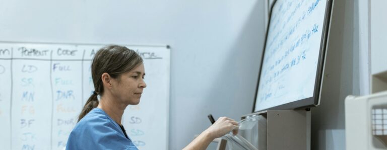 Nurse arranging medical supplies in a healthcare setting, highlighting organization and care.